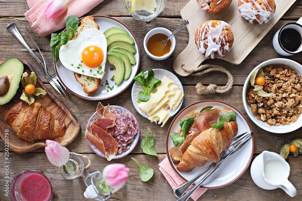 Breakfast food table. Festive brunch set, meal variety with fried egg ...