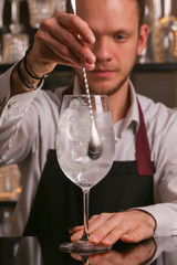 Wall Mural - Barmen is making Aperol Spritz cocktail.  Alcohol cocktail on black background surface