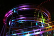 colorfully lit roller coaster track at night