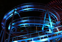 Colorfully Lit Roller Coaster Track At Night