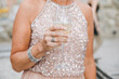 © IVASHstudio - Woman in sparkling pink dress holds glass of champagne in her arm