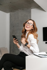 Poster - Business woman dressed in formal clothes shirt indoors using mobile phone.