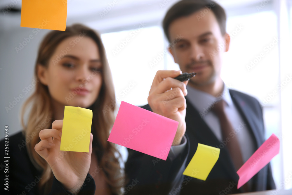 View at business team during meeting in office through transparent board