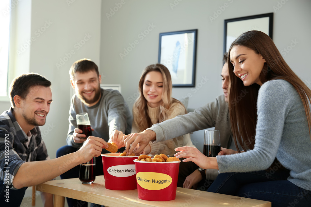 Group of friends eating nuggets at home