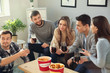 © Pixel-Shot - Group of friends eating nuggets and drinking soda at home