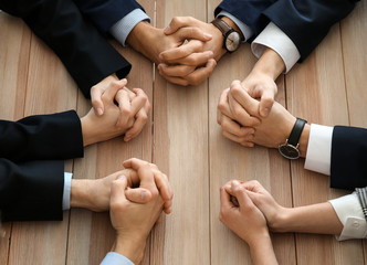 Wall Mural - Group of people praying before meeting in office