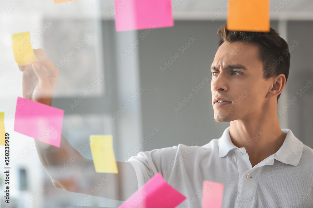 View at man during business meeting in office through transparent board