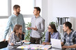 © Pixel-Shot - Group of people discussing business plan in office