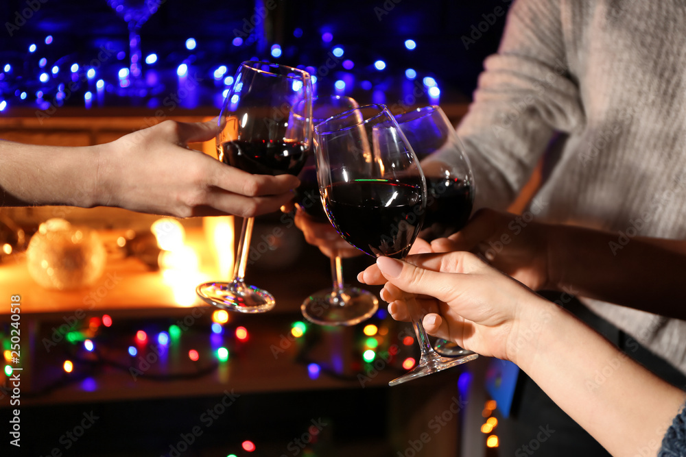 Women clinking glasses with tasty wine in bar
