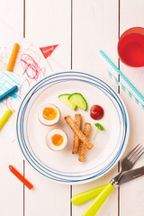 Wall Mural - Kid's breakfast - eggs, toasts, cucumber and ketchup