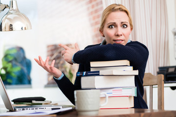 Wall Mural - Worried woman with stack of books