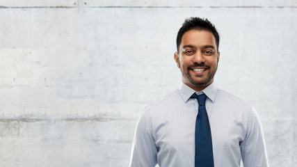 Sticker - business, office worker and people concept - smiling indian businessman in shirt with tie over gray concrete wall background