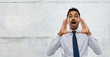 business, stress and people concept - indian businessman shouting or calling over gray concrete wall background