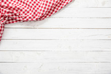 Red Checkered Kitchen Tablecloth On Wooden Table.