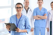 © Pixel-Shot - Female doctor and her colleagues in clinic