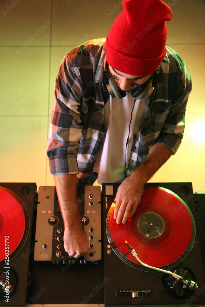 Male DJ playing music in club, top view