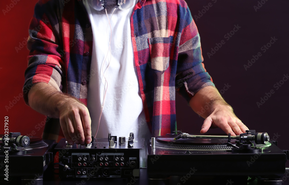 Male DJ playing music in club
