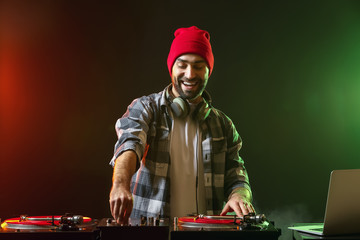 Male DJ playing music in club