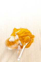 Canvas Print - turmeric powder in glass bowl on wood