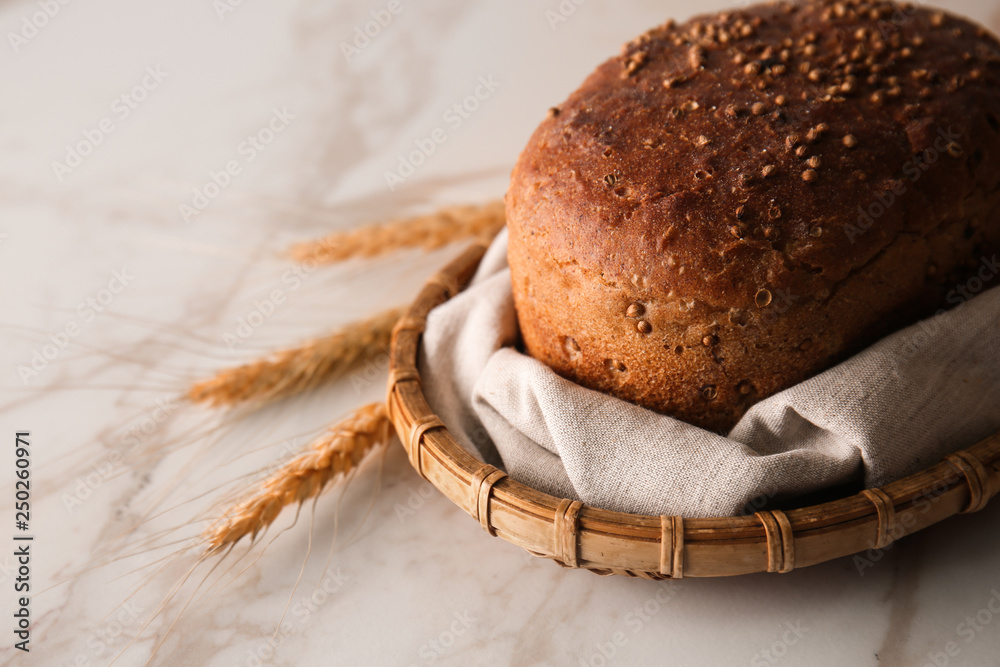 Loaf of fresh bread on light background