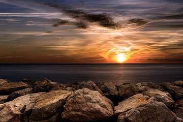 Wall Mural - Sunset in the Mediterranean Sea with breakwater