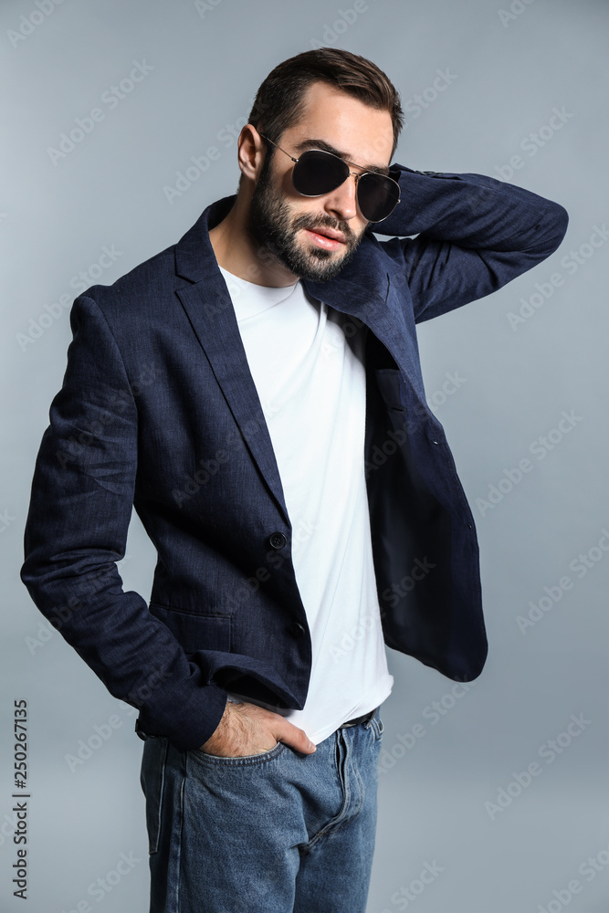 Handsome fashionable man on grey background