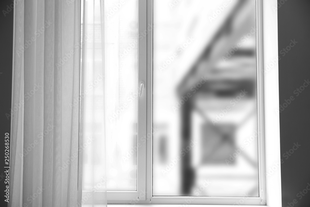 Modern window with light curtains in flat