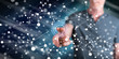 © thodonal - Man touching a virtual network