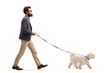 © Ljupco Smokovski - Bearded man walking a maltese poodle dog