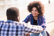© simona - Beautiful cheerful African american girl have fun and smile with boyfriend or friend outdoor - afro curly hair style - happy people enjoying love and friendship - casual hipster teenager outside
