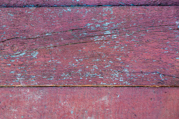 Old wooden planks background texture with cracked red and blue paint