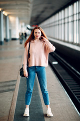 Wall Mural - Positive redhead young female in subway portrait