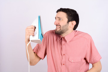 Wall Mural - Young funny man with an iron.