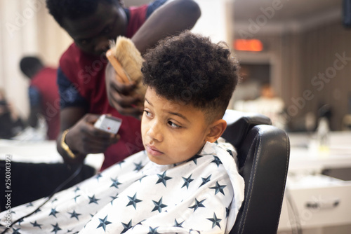 Boy In The African Barbershop Cute Mixed Boy Makes A Haircut In