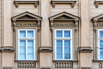 Artistic window and facades decorations of historic tenement houses in Krakow.