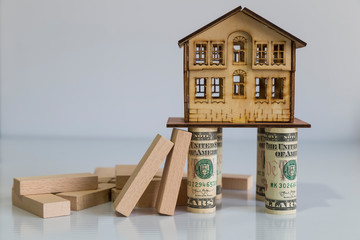 Real estate and mortgage investment. House and wooden blocks on the background.