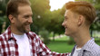 © motortion - Proud father looking at son, congratulating with entering university, success