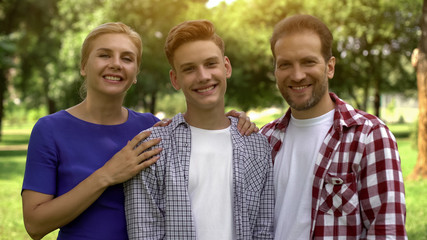 Happy family looking at camera, proud of his son, student exchange program