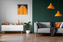 Abstract Orange Painting On Grey Wall Of Stylish Living Room Interior With White Wooden Furniture And Grey Couch
