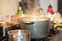 Pots Cooking On Stove With Steam