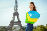 Fototapeta Paryż - woman with shopping bags against Eiffel tower in Paris, France