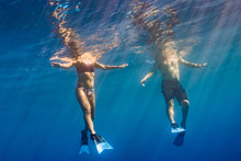 Man And Woman Floating In The Ocean