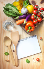 Wall Mural - Colourful different raw vegan food and empty text space book page on wooden table top.