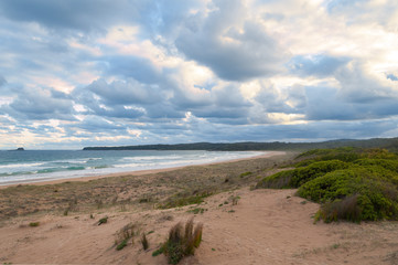 Wall Mural - Beautiful beach sunset with sunlit clouds and empty beach