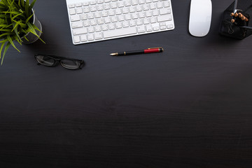 Fototapete - Flat lay of top view modern black wood desk work table with computer laptop and stationary in home office includes copyspace for add text or graphic