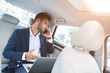 © Friends Stock - A young man in the car discussing business matters by phone