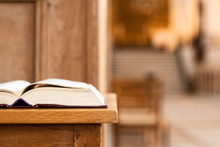 Holy Book On A Table In Front Of The Altar Of The Church And With A View To The Great Big Churchroom