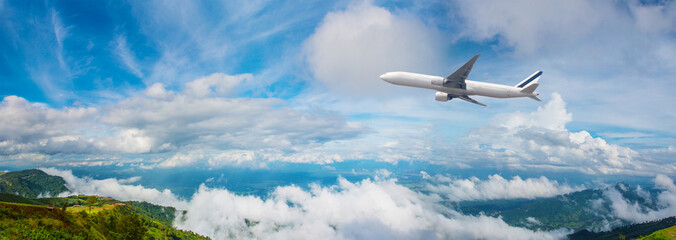 Panorama Photo An airplane flying in the blue sky. passenger plane flies highly over clouds of aerosphere.  airplane flying in a clear pale blue sky. An airplane taking off at airport.