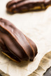 Fresh eclair with chocolate glaze. Selective focus. Shallow depth of field.