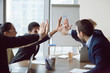 Excited business team give high five celebrate corporate success